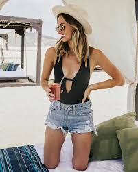An armless top or a swim suit and a denim short